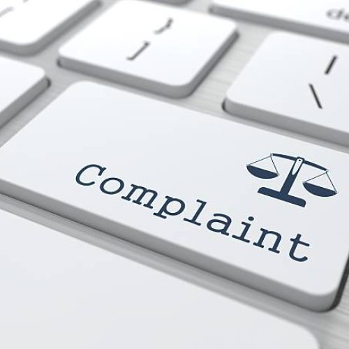White Button with Complaint on Computer Keyboard. Business Concept.